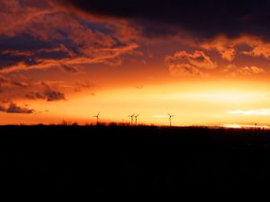 Preview wallpaper wind turbines, sunset, horizon, clouds