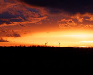 Preview wallpaper wind turbines, sunset, horizon, clouds