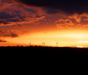 Preview wallpaper wind turbines, sunset, horizon, clouds