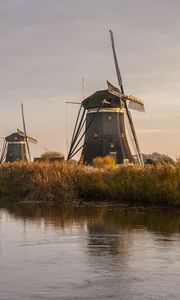 Preview wallpaper windmill, river, water, buildings, nature