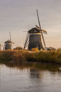 Preview wallpaper windmill, river, water, buildings, nature