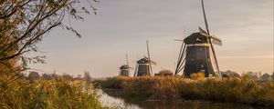 Preview wallpaper windmill, river, water, buildings, nature