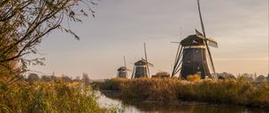 Preview wallpaper windmill, river, water, buildings, nature