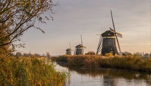 Preview wallpaper windmill, river, water, buildings, nature