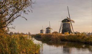 Preview wallpaper windmill, river, water, buildings, nature