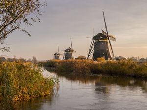 Preview wallpaper windmill, river, water, buildings, nature