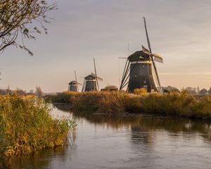 Preview wallpaper windmill, river, water, buildings, nature