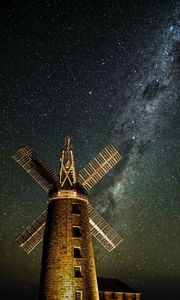 Preview wallpaper windmill, tower, building, night, starry sky, stars