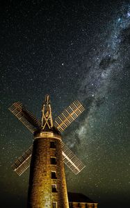 Preview wallpaper windmill, tower, building, night, starry sky, stars