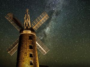 Preview wallpaper windmill, tower, building, night, starry sky, stars