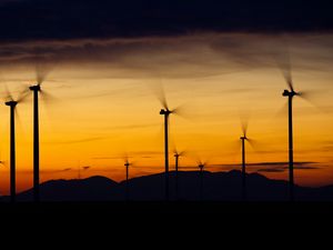 Preview wallpaper windmills, sunset, energy, wind, electricity, movement, blades, dark, horizon