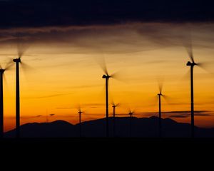 Preview wallpaper windmills, sunset, energy, wind, electricity, movement, blades, dark, horizon