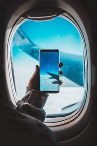 Preview wallpaper window, plane, wing, hand, smartphone