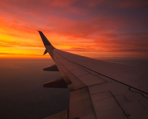 Preview wallpaper wing aircraft, flight, sky, sunset