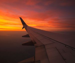Preview wallpaper wing aircraft, flight, sky, sunset