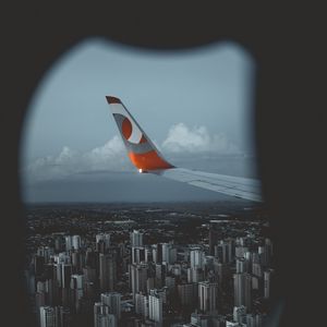 Preview wallpaper wing aircraft, porthole, city, view from above, flight