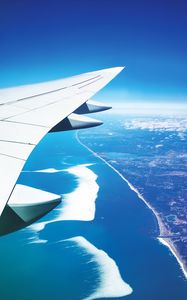 Preview wallpaper wing, plane, view from above, city, flight, ocean