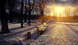 Preview wallpaper winter, park, sunset, bench, snow, sun