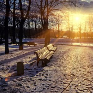 Preview wallpaper winter, park, sunset, bench, snow, sun